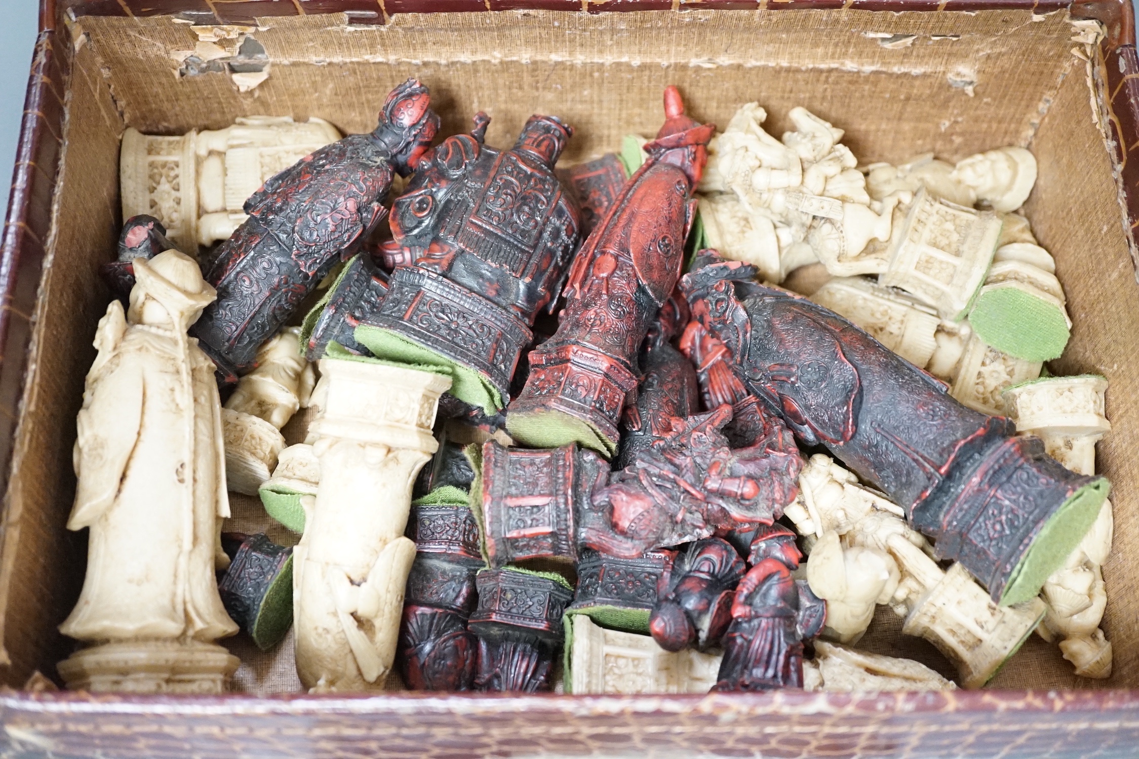 A moulded resin chess set in faux crocodile suitcase